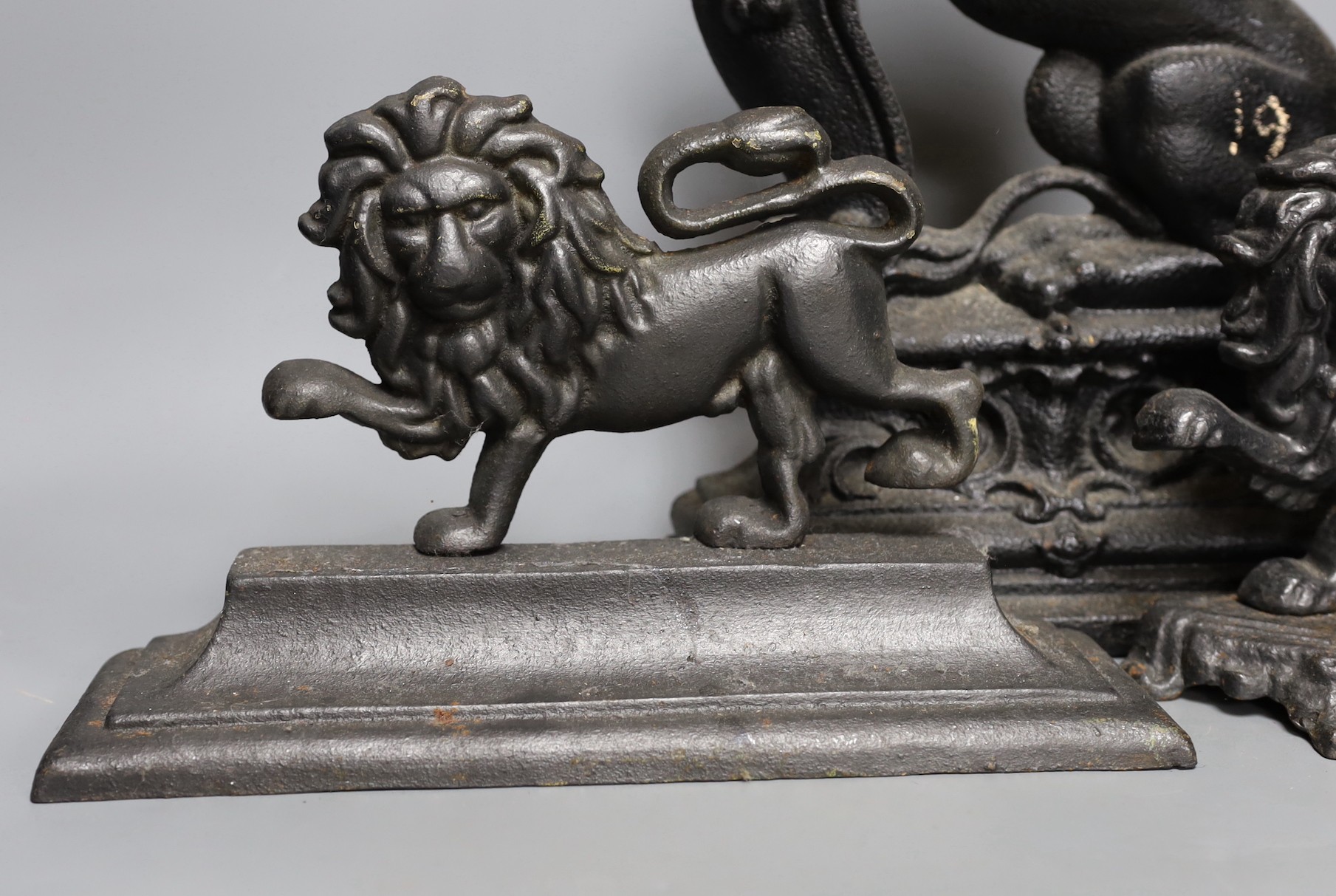 Four cast iron ‘lion’ door stops, 39cm